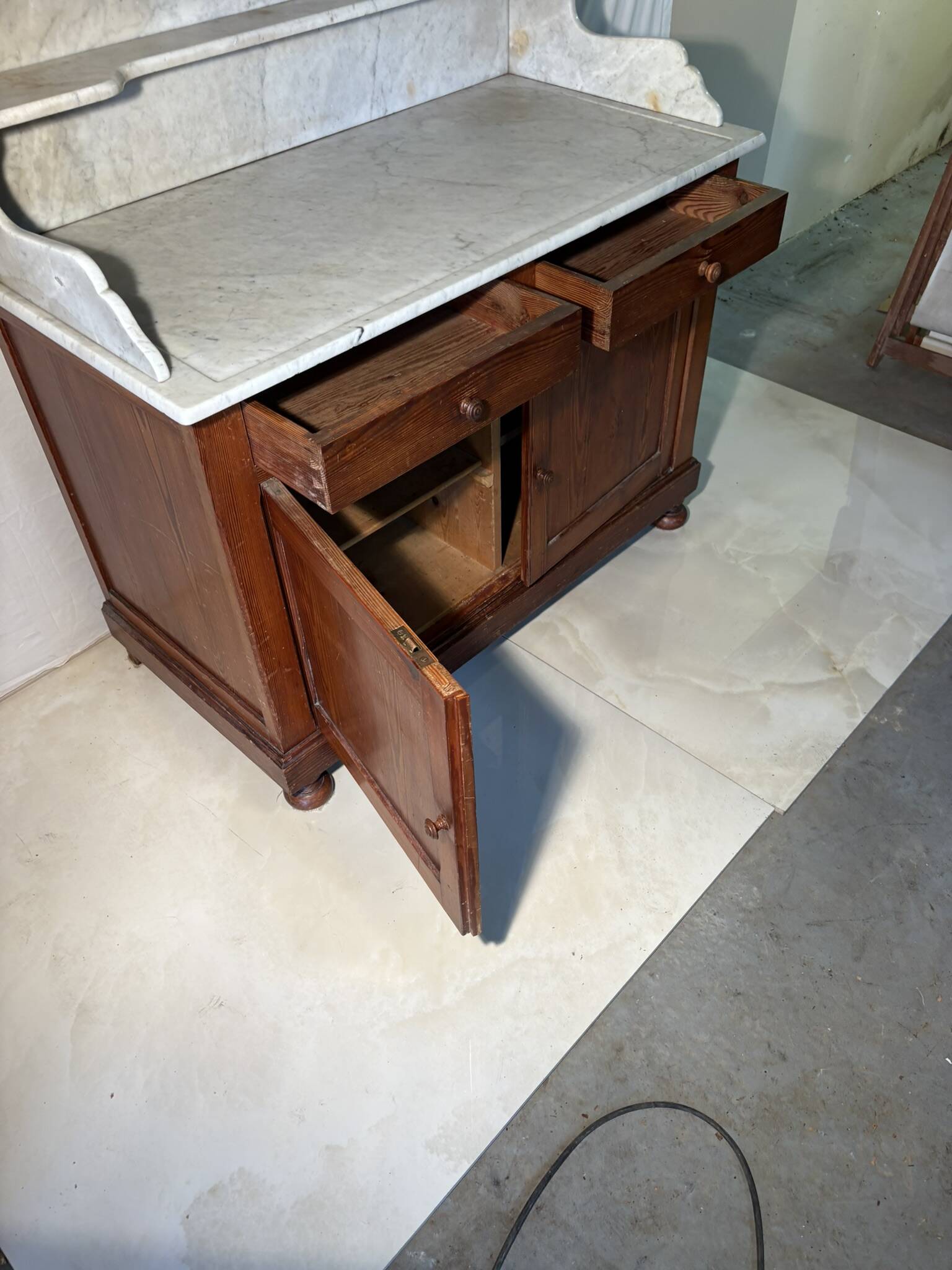 Antique wood and marble kitchen sideboard with carved backsplash
