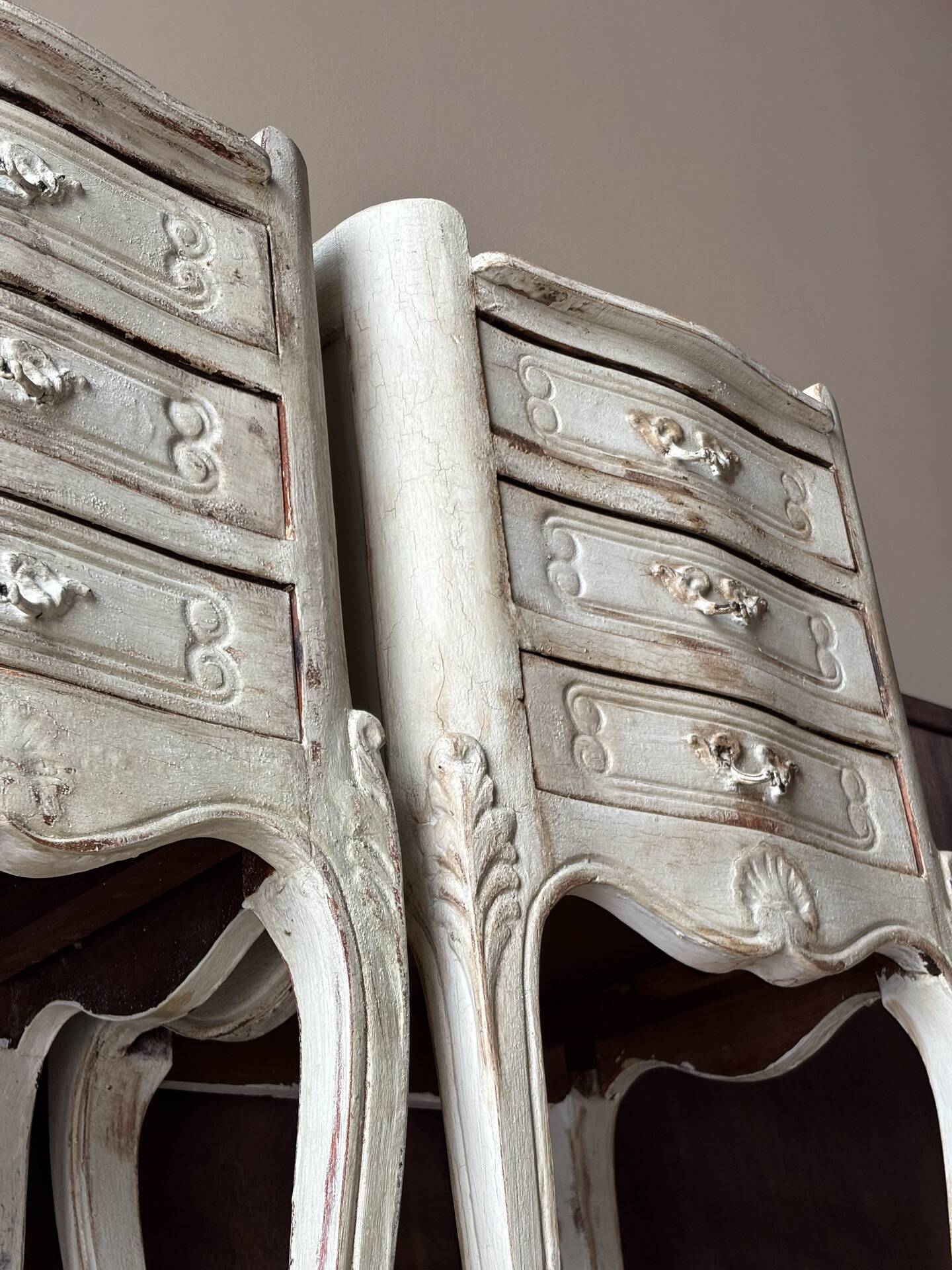 A pair of distressed bedside tables.