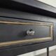 Large flat desk in Louis XVI style, black lacquered with gold highlights.