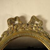 Golden oval mirror