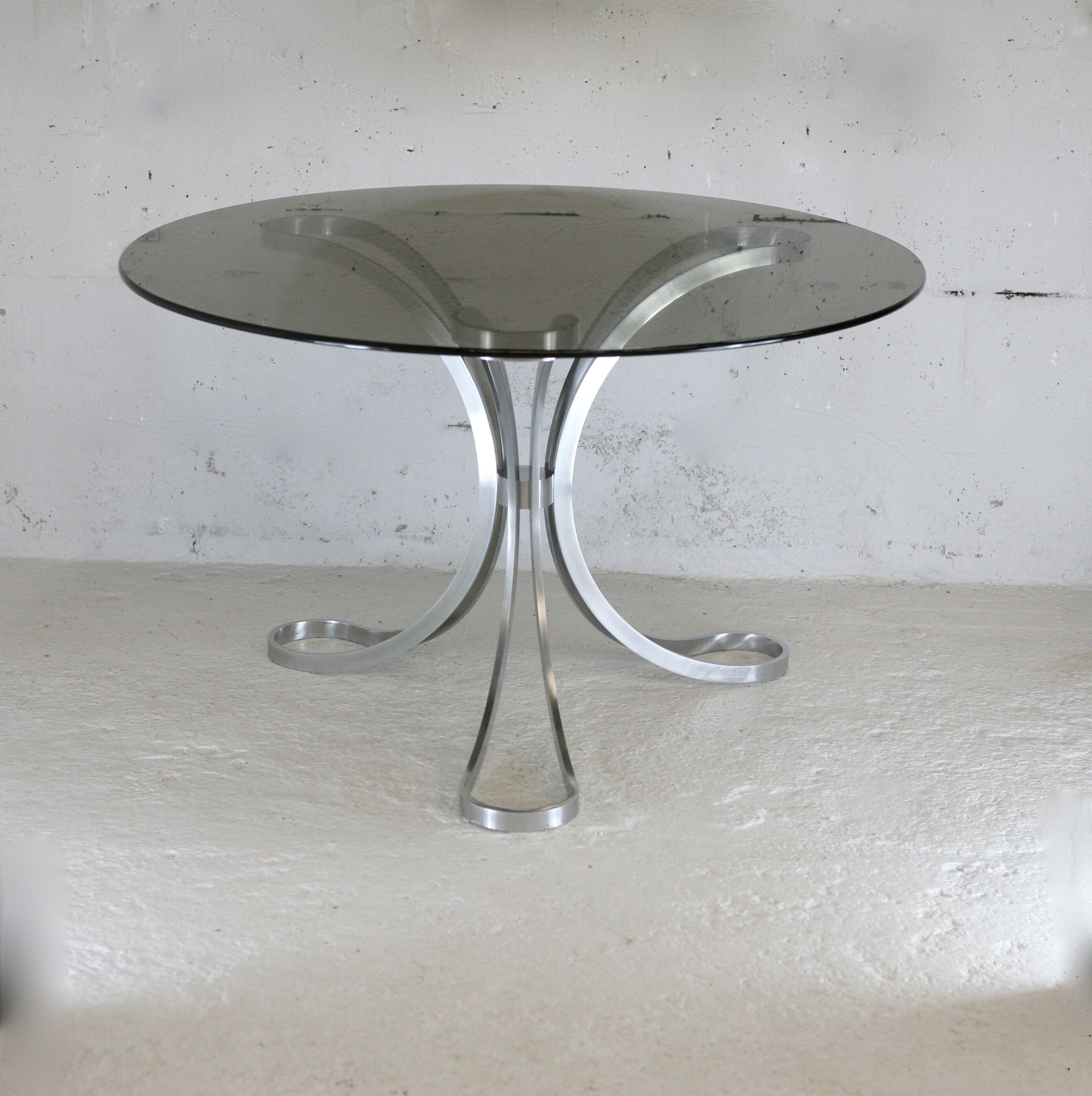 Living room table "Space Age" polished steel, circular slab smoked glass. France, circa 1970.