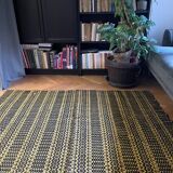 Romanian vintage carpet black design on a yellow background