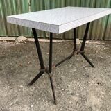 Vintage bistro table with an Art Deco style cast iron base and Formica top.