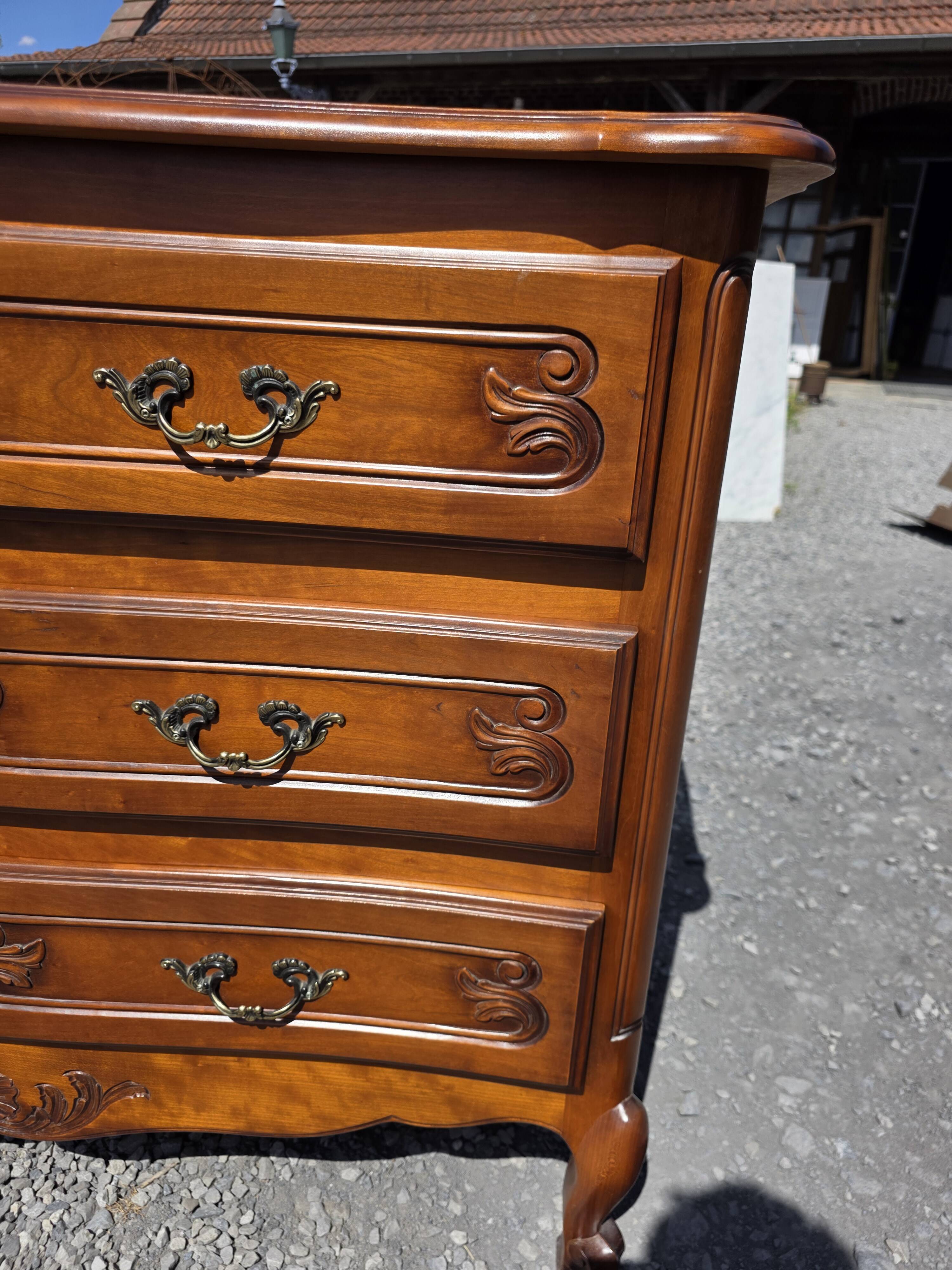 Curved commode in Louis XV style made of cherry wood.
