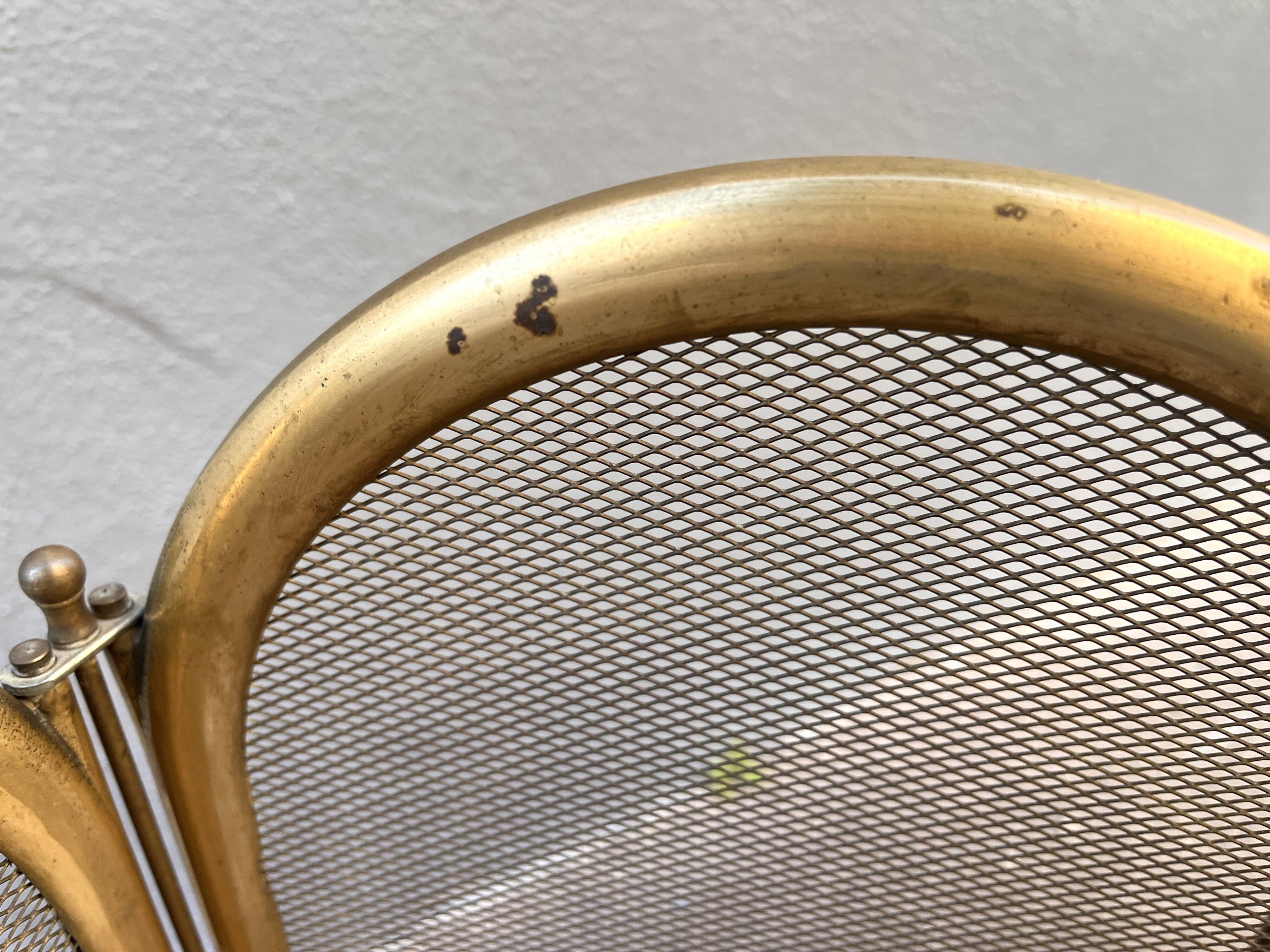 Antique brass fireplace screen from 1920, vintage spark guard.