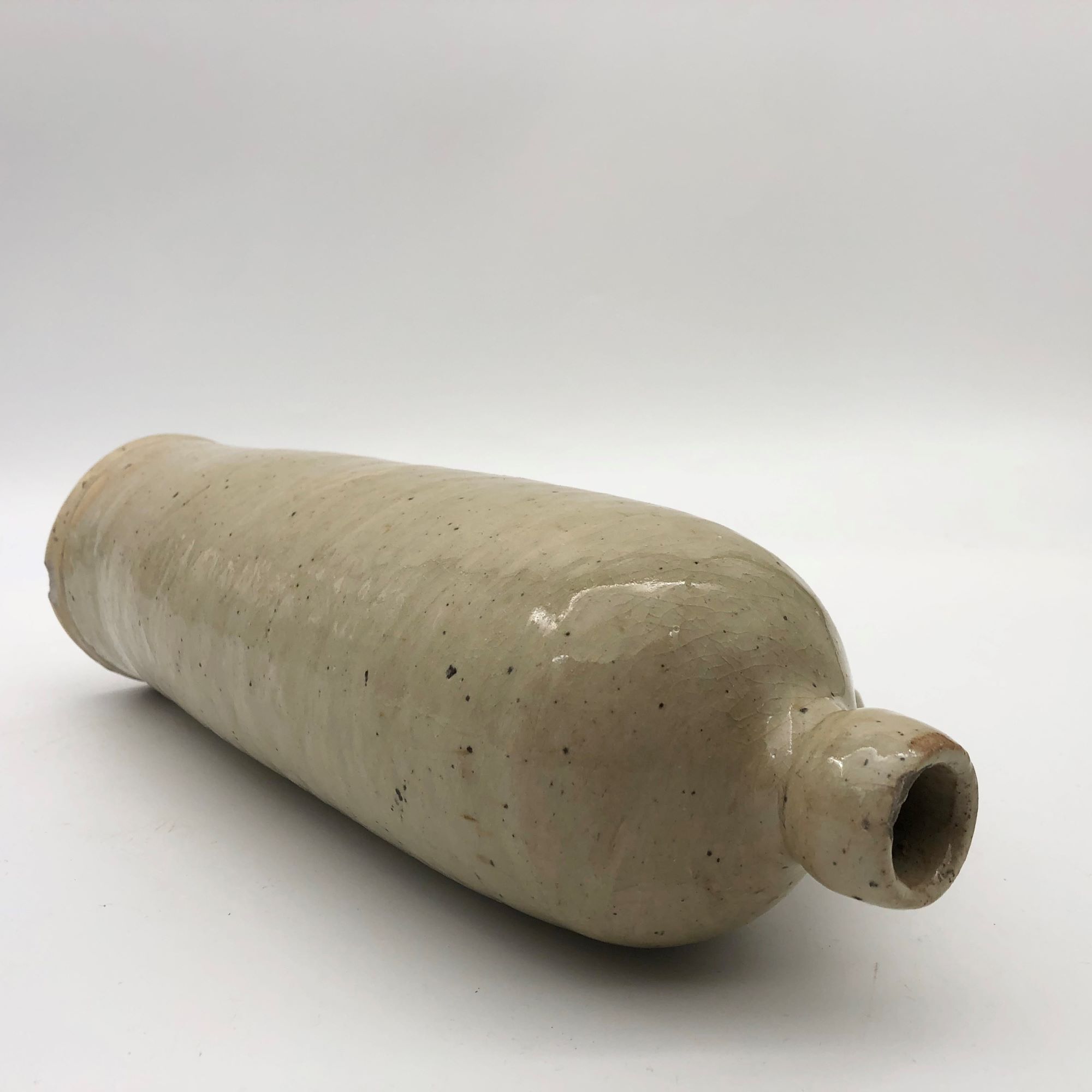 Old hot water bottle in glazed stoneware, beige color