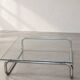 Coffee table in chrome with a glass top.