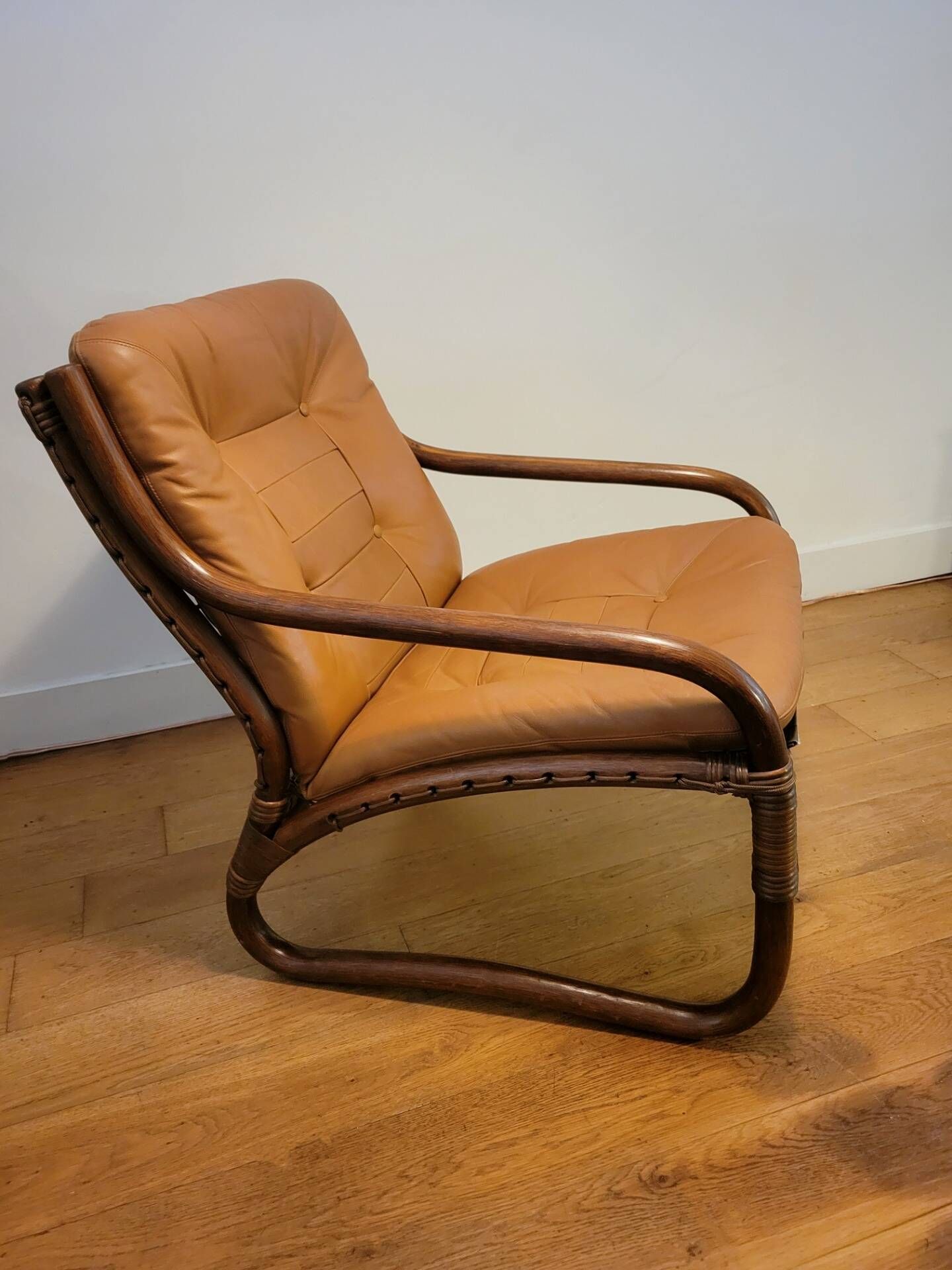 Vintage rattan armchair with leather cushions from 1970