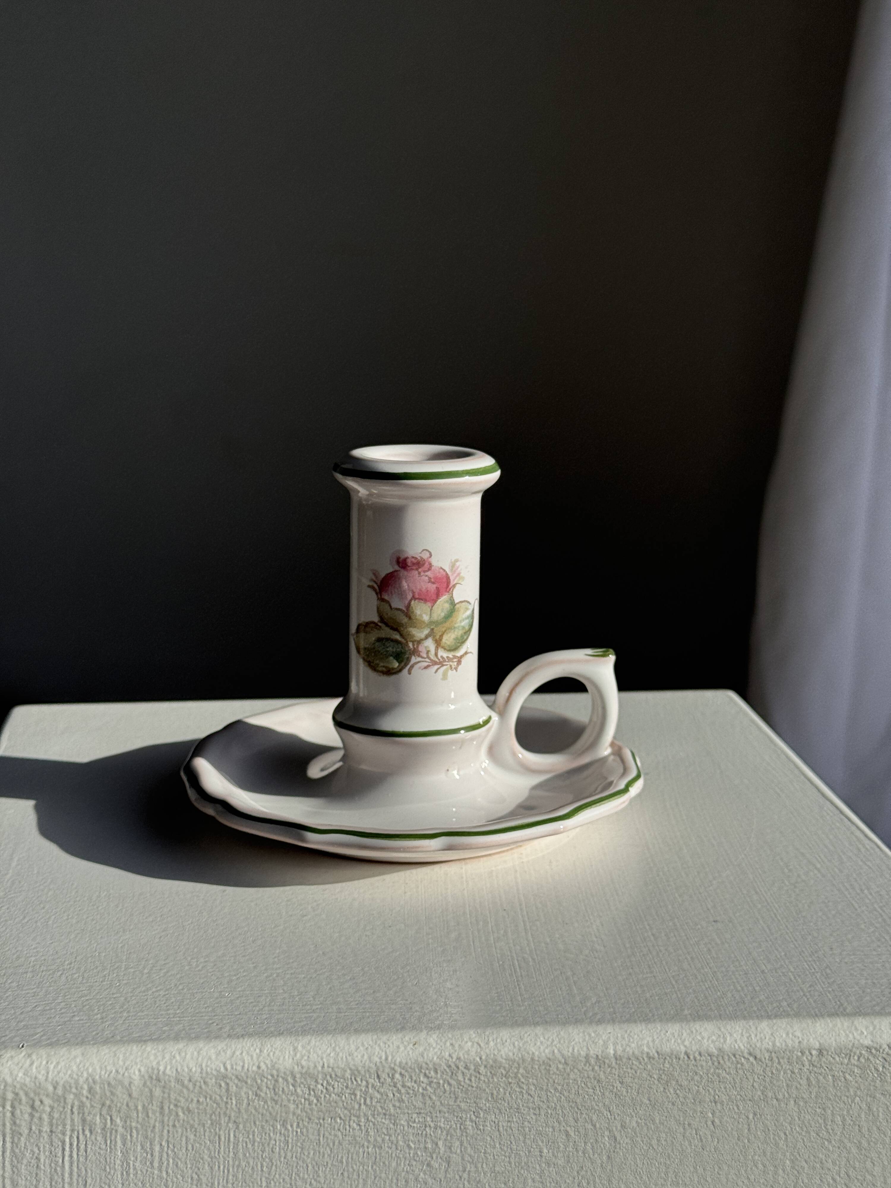 Small vintage hand-held candlestick in earthenware with green trim and floral decoration H10.5