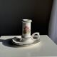 Small vintage hand-held candlestick in earthenware with green trim and floral decoration H10.5