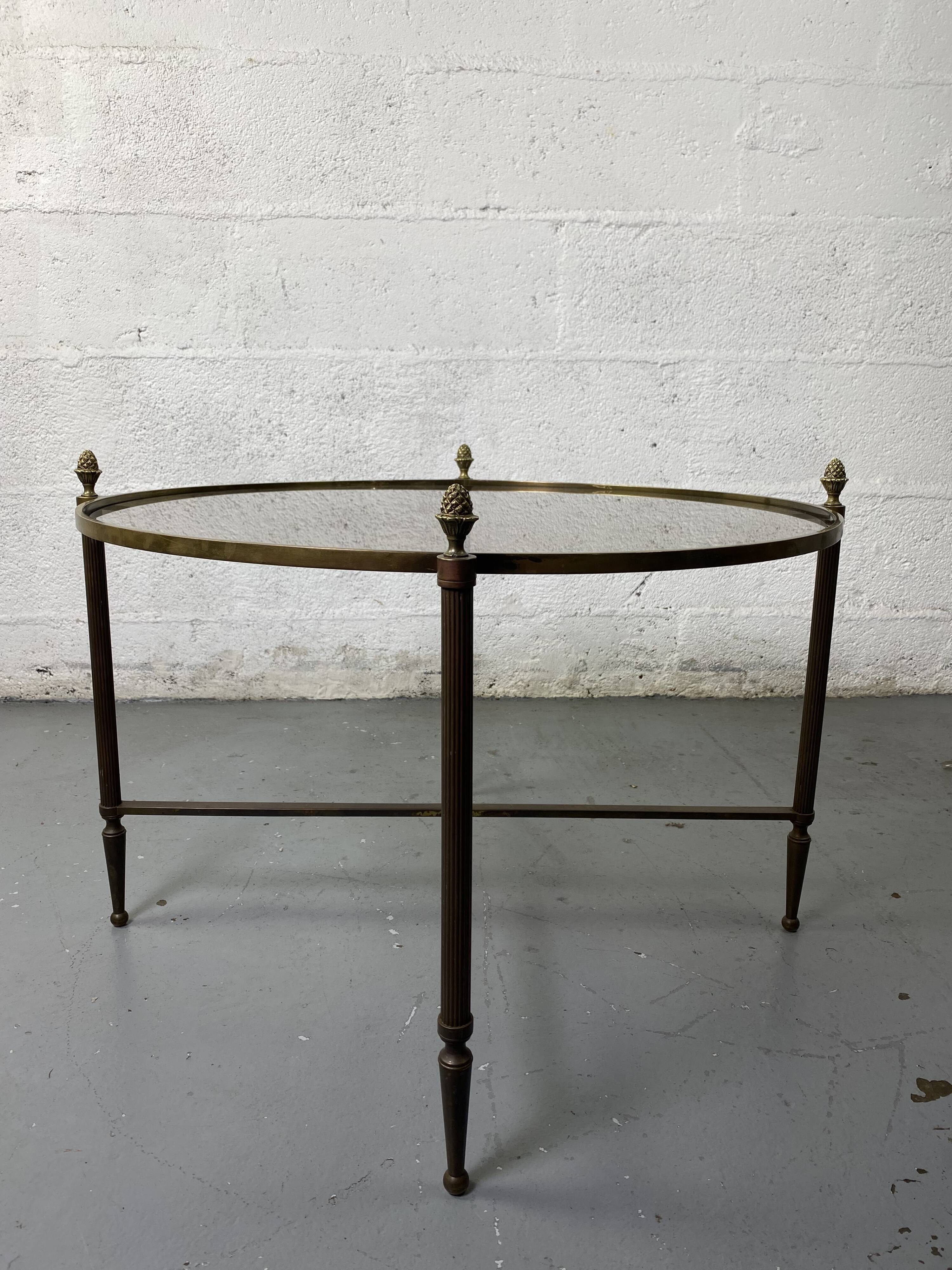 Round coffee table in brass and smoked glass