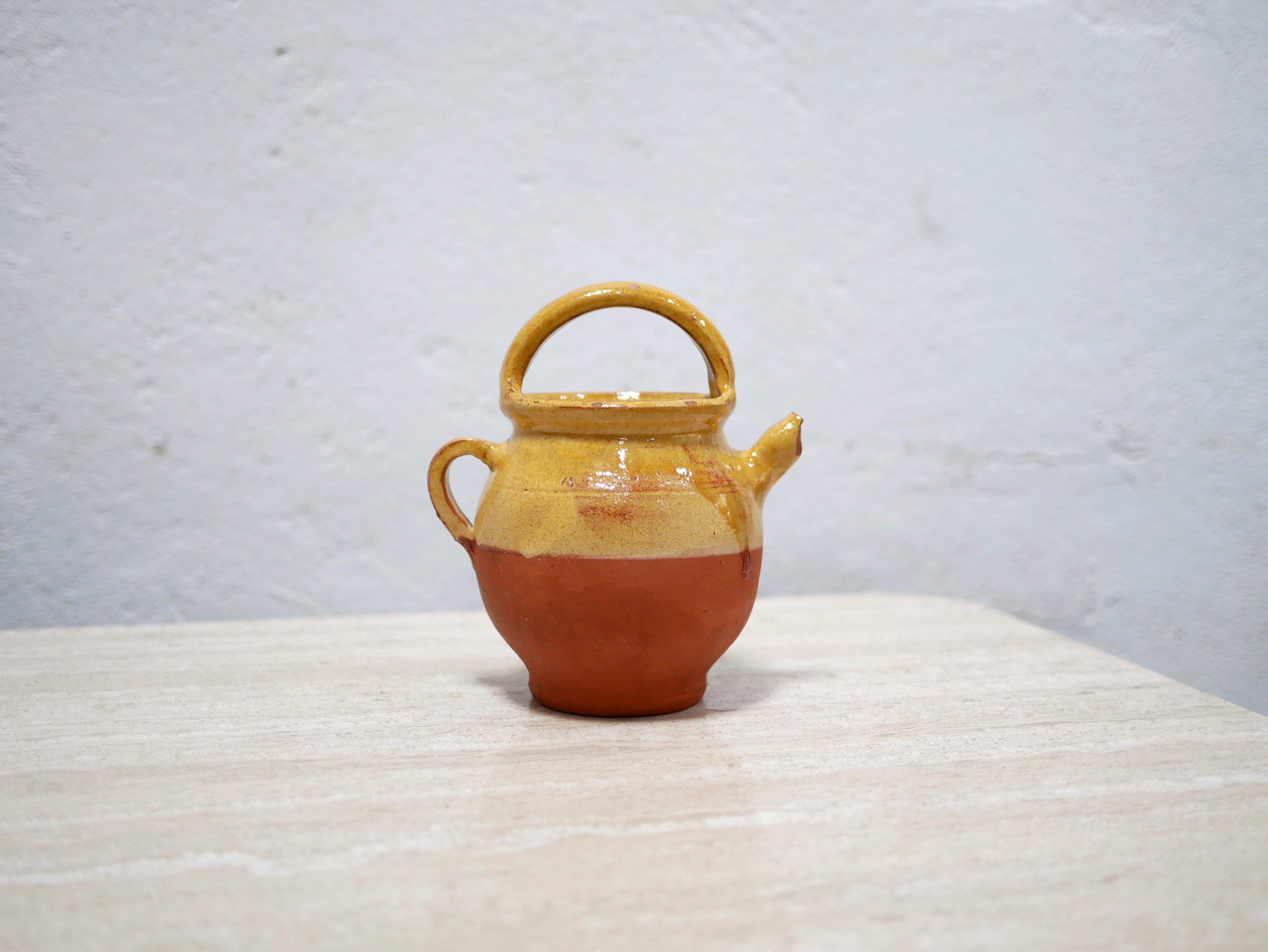 Old gargoulette pot in glazed terracotta