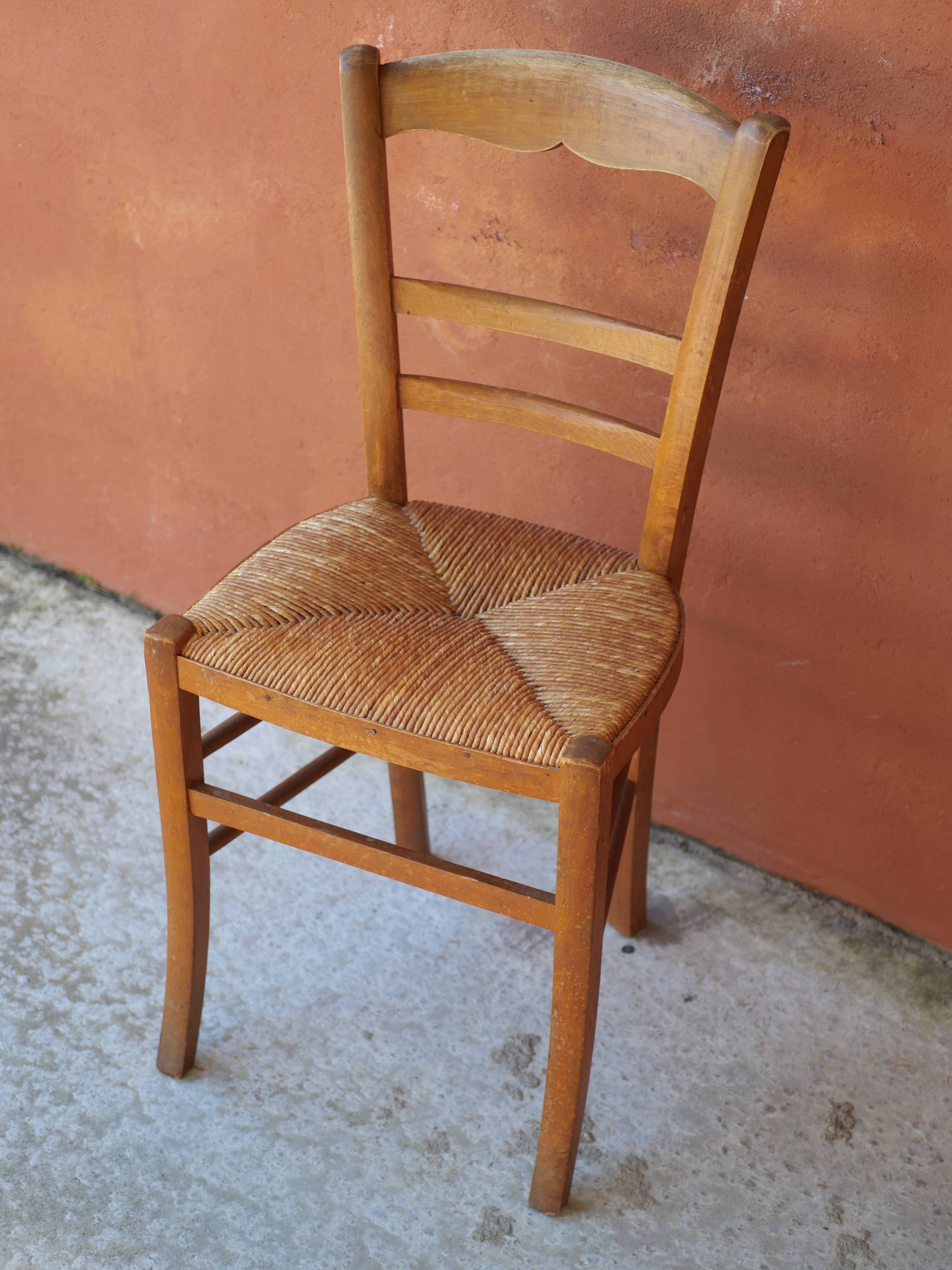 Set of 5 mismatched straw chairs.