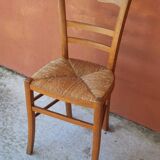 Set of 5 mismatched straw chairs.