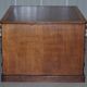 Antique Victorian oak kneehole desk with 18 double-sided drawers.