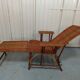 Sunbathing sunbathing in wicker rattan wood deckchair red lounger