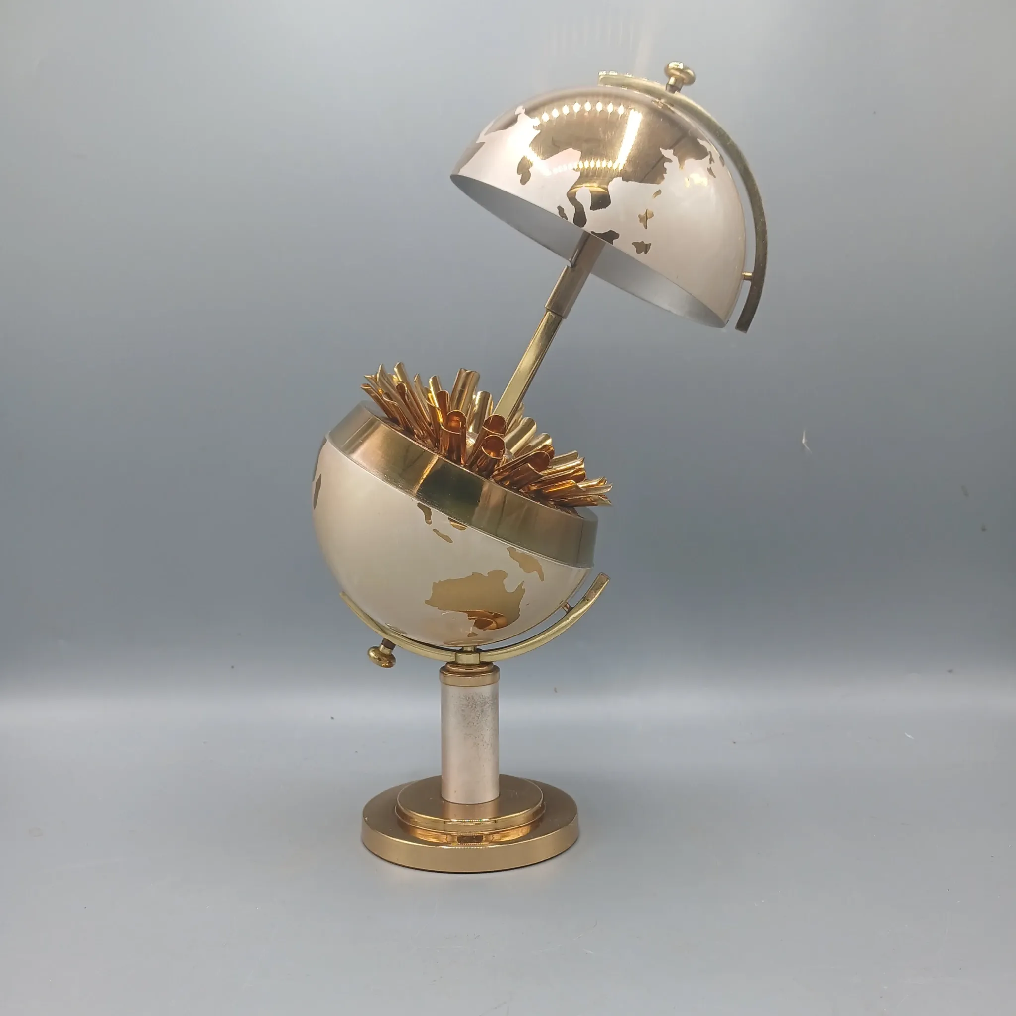 Vintage brass globe cigarette dispenser