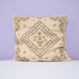 Vintage beige embroidered cushion green motif