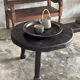 Small antique Indonesian bench in carved teak with plant and floral motifs.