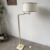 Floor lamp with articulated arm in brass-plated metal