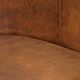 Sheepskin club armchair in a brown colour finished with decorative nails