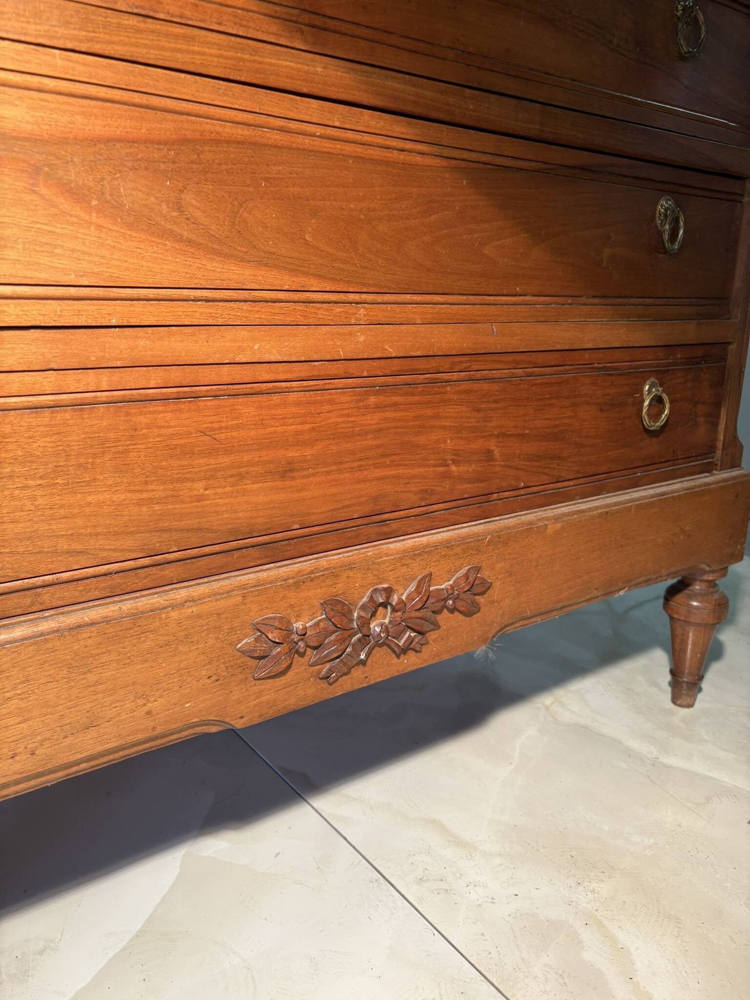 Antique carved wooden dressing table with marble and tilting oval mirror.