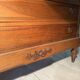 Antique carved wooden dressing table with marble and tilting oval mirror.