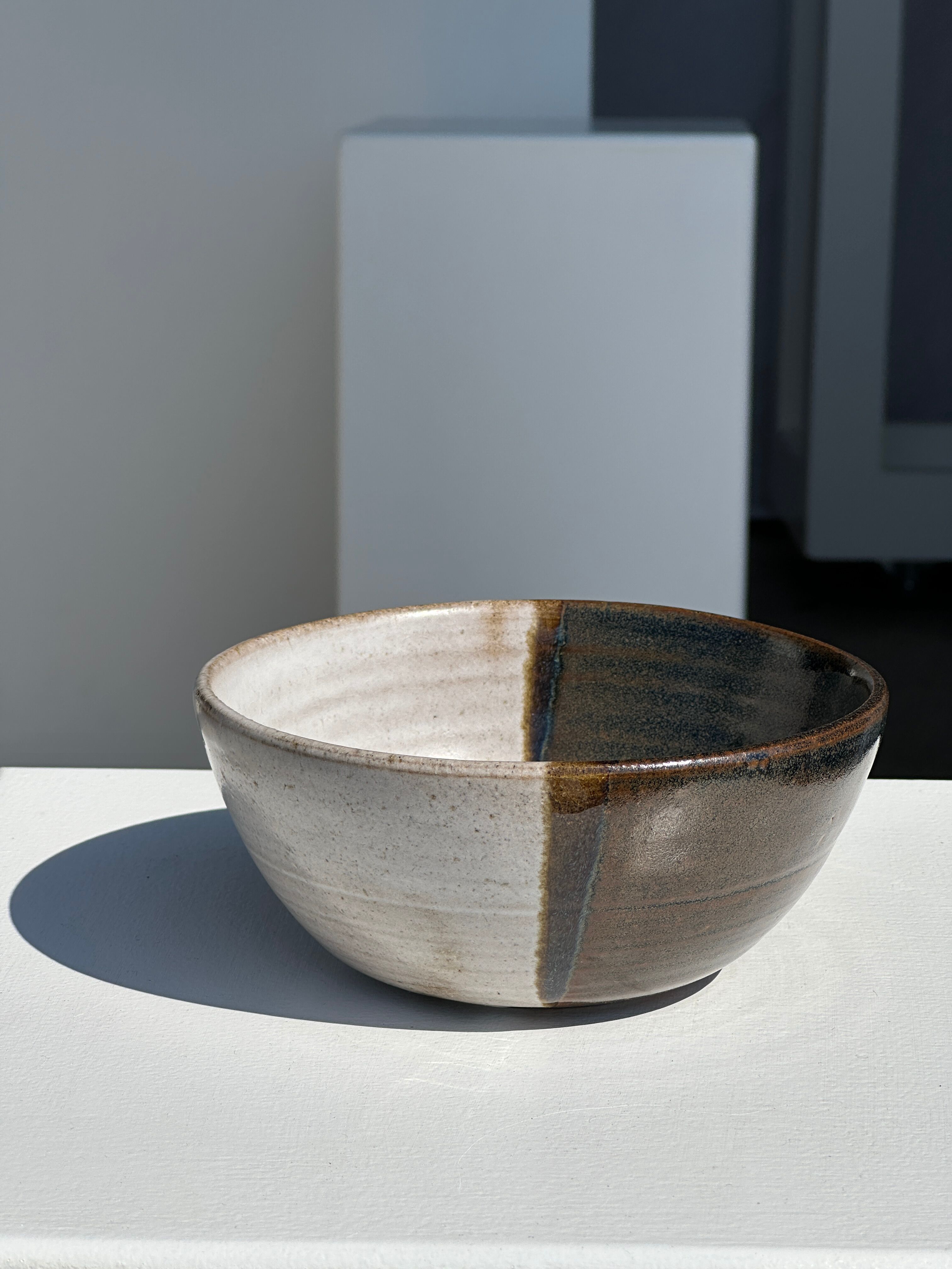 White and glossy brown two-tone ceramic bowl, matt earth