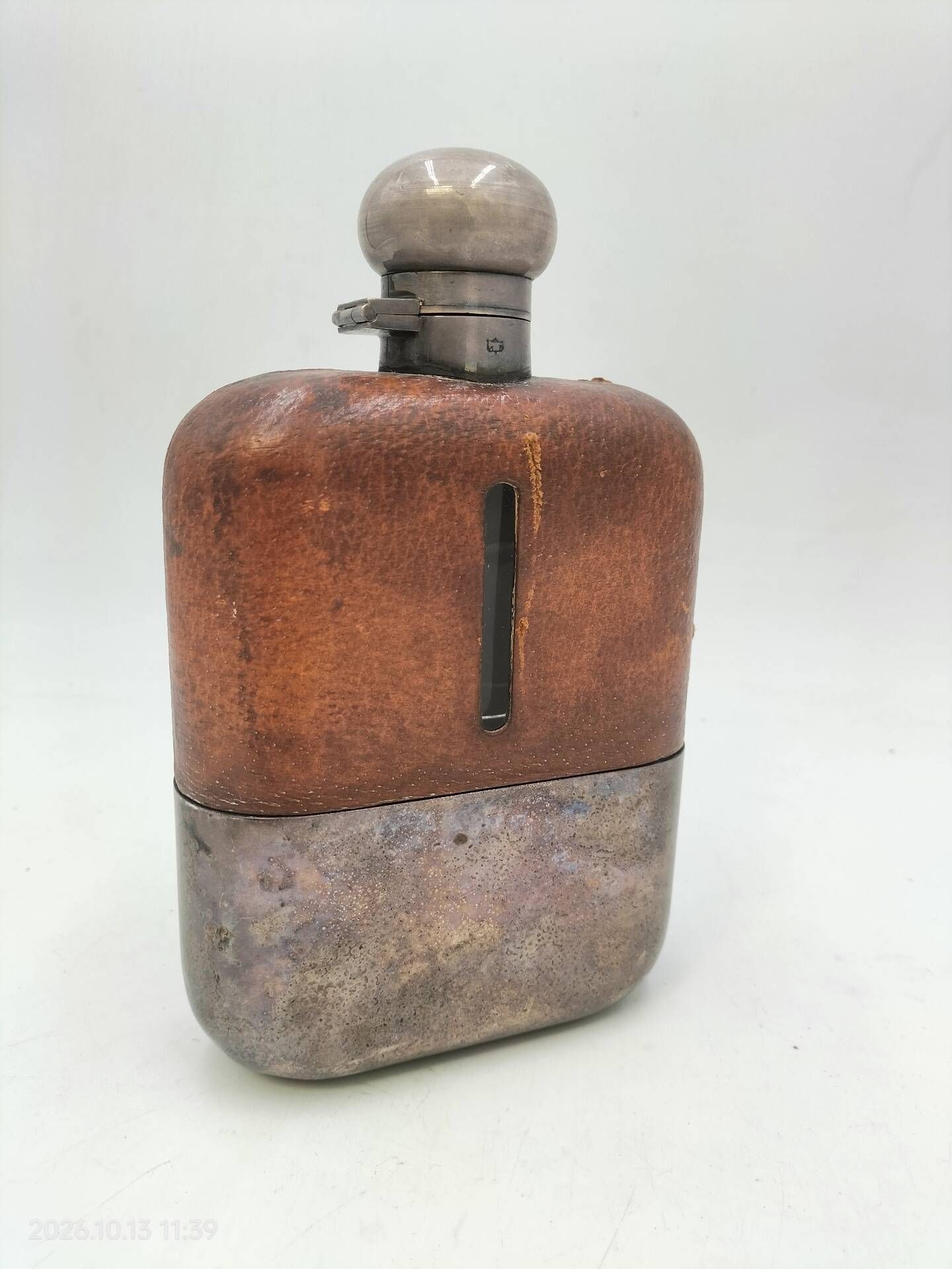 Silver-plated metal flask with leather and glass