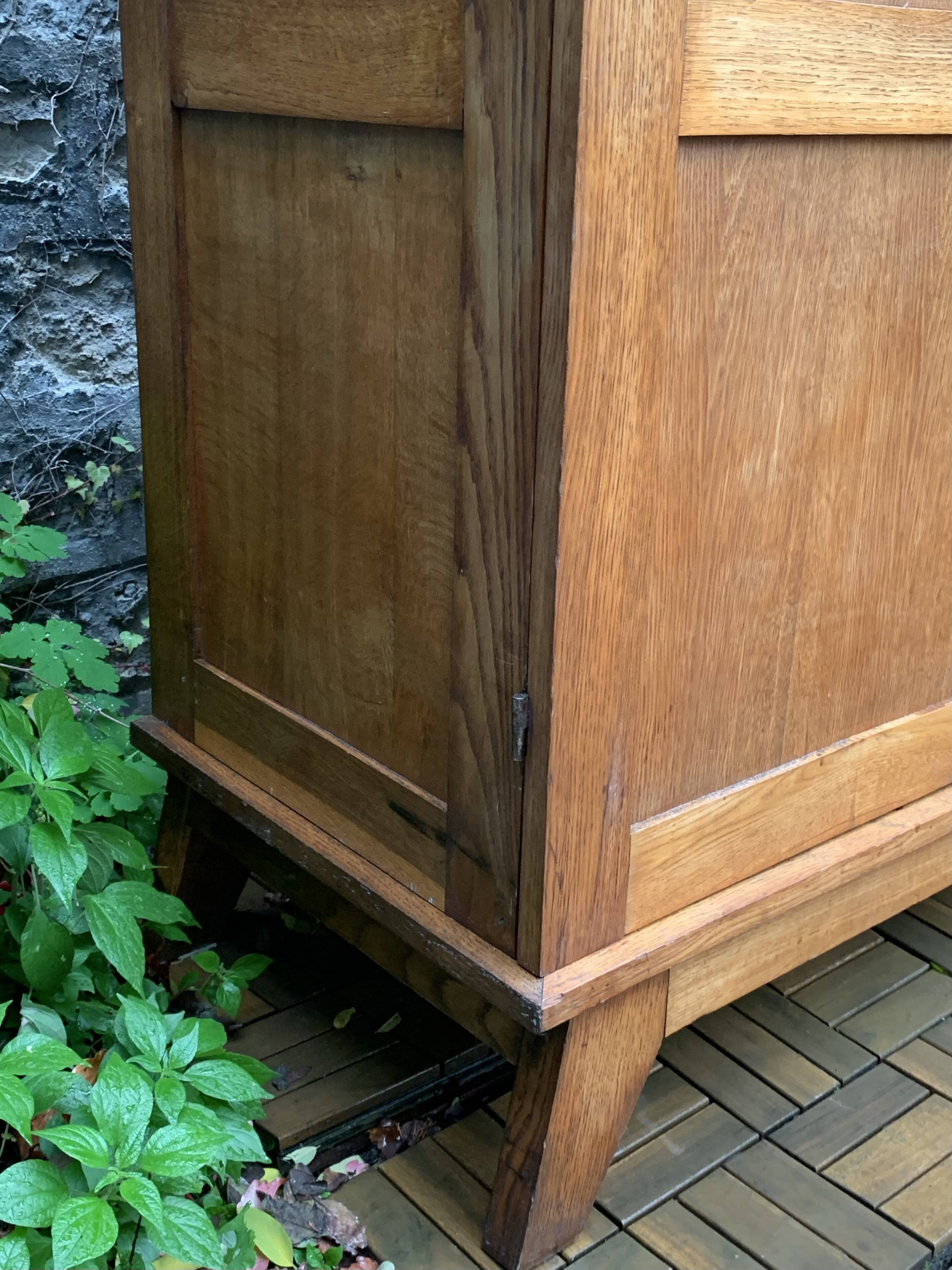 Solid oak compass foot cabinet René Gabriel 1945