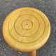Vintage low tripod stool with carved light oak legs.