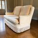Vintage beige two-seater sofa with fringes