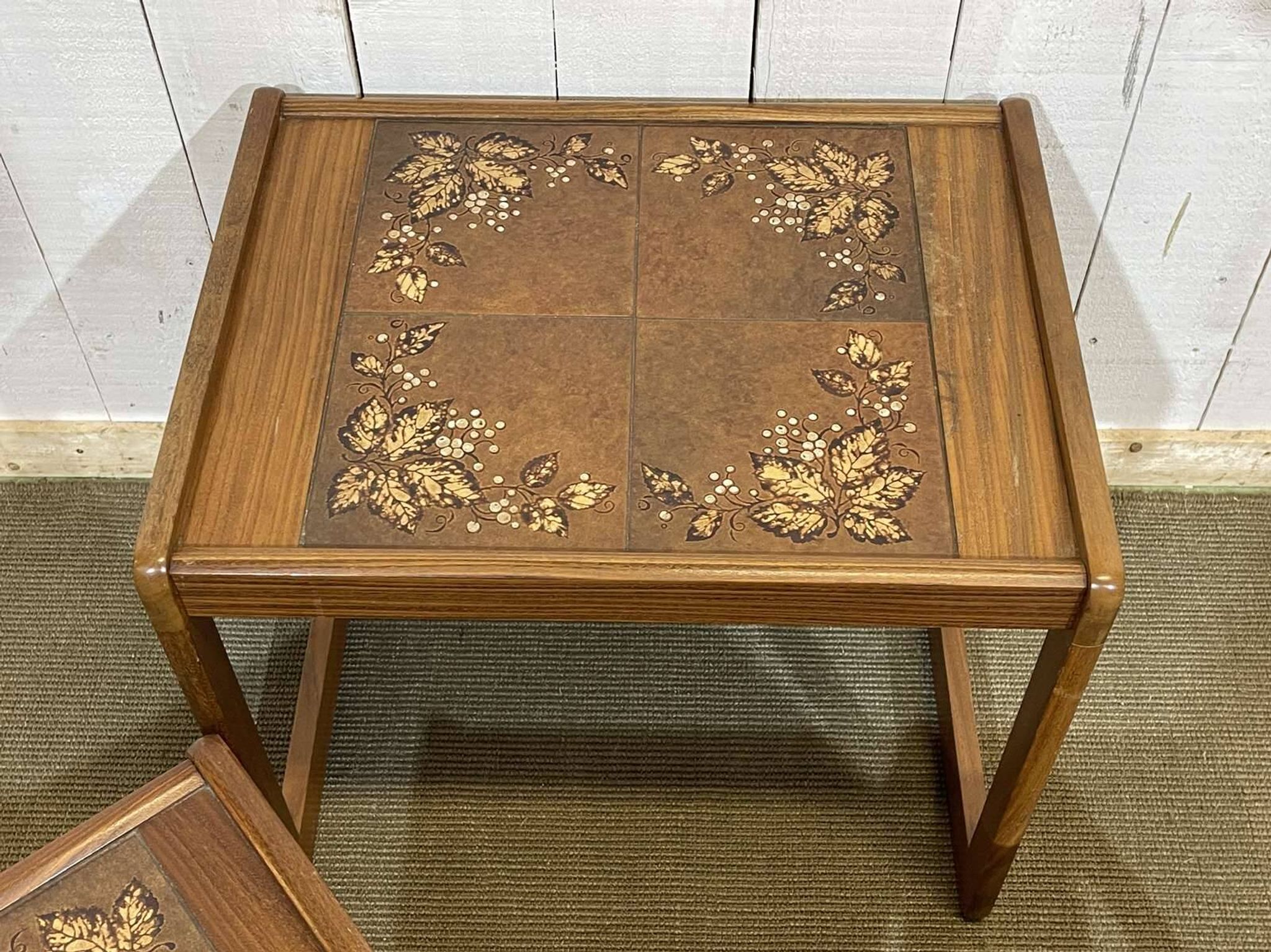 Set of 3 nesting tables in teak with tiled tops.