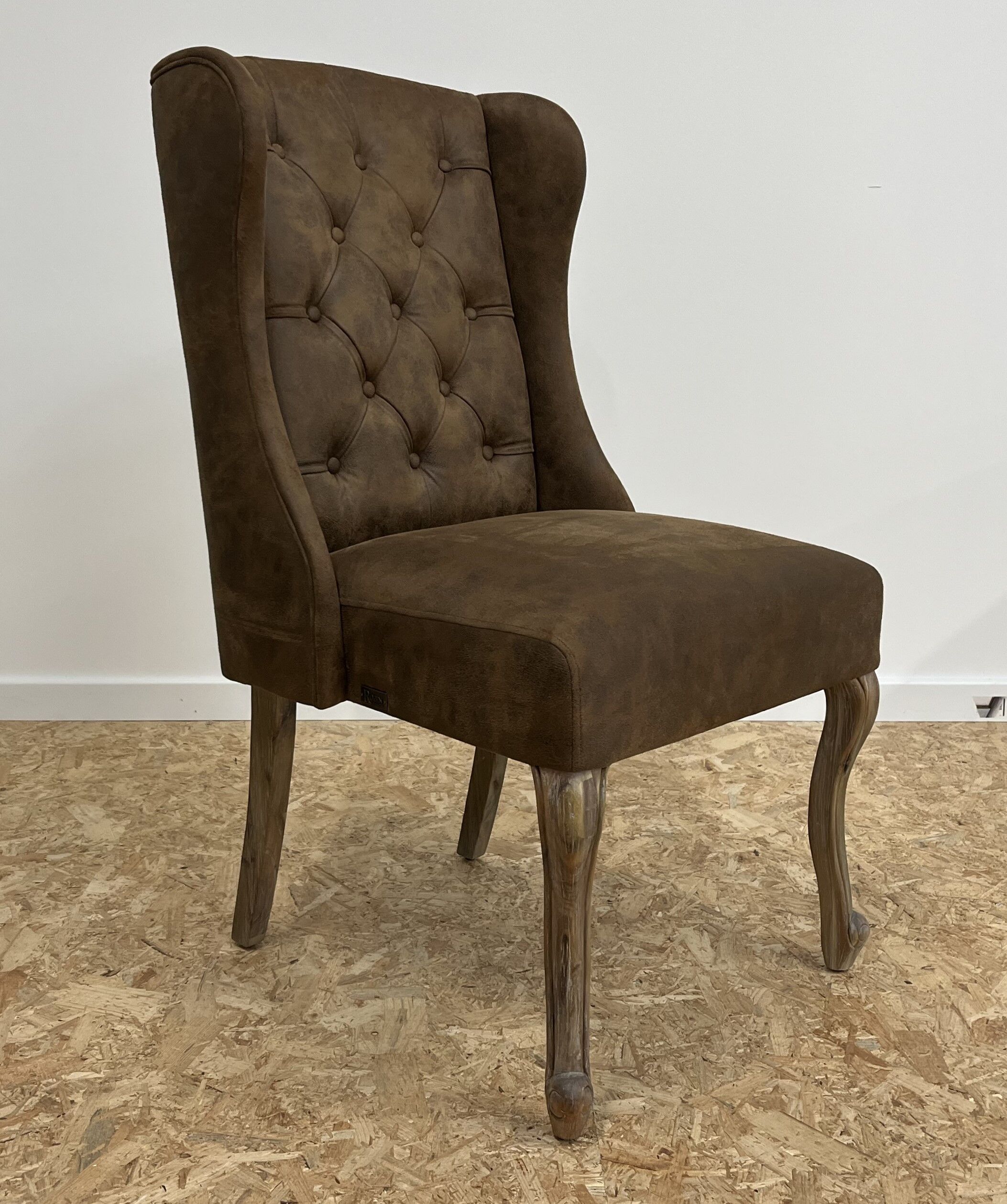 Upholstered armchair in brown imitation leather