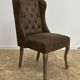 Upholstered armchair in brown imitation leather