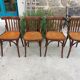 4 bentwood bistro chairs with a pattern on the seat