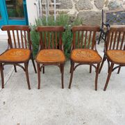 4 bentwood bistro chairs with a pattern on the seat