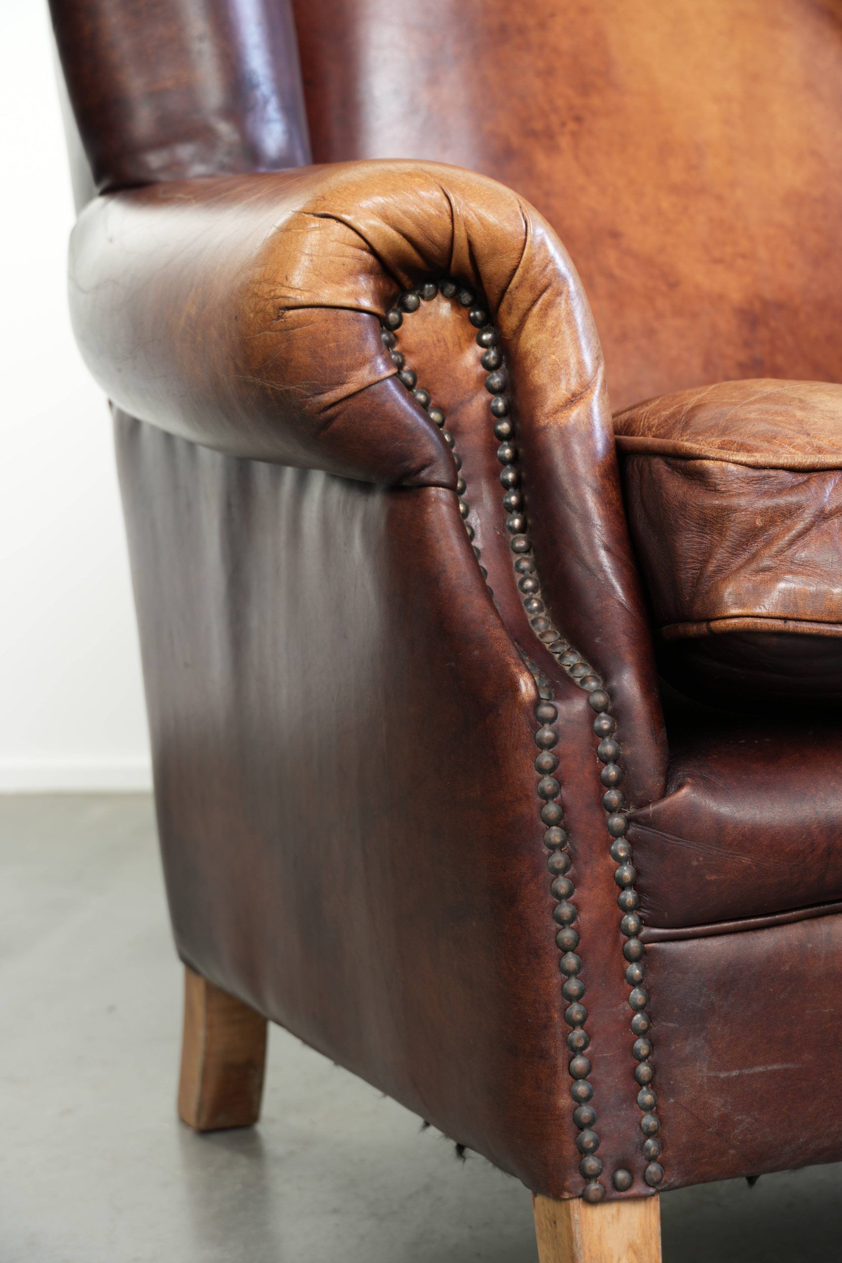 Comfortable cowhide wingback armchair in English style