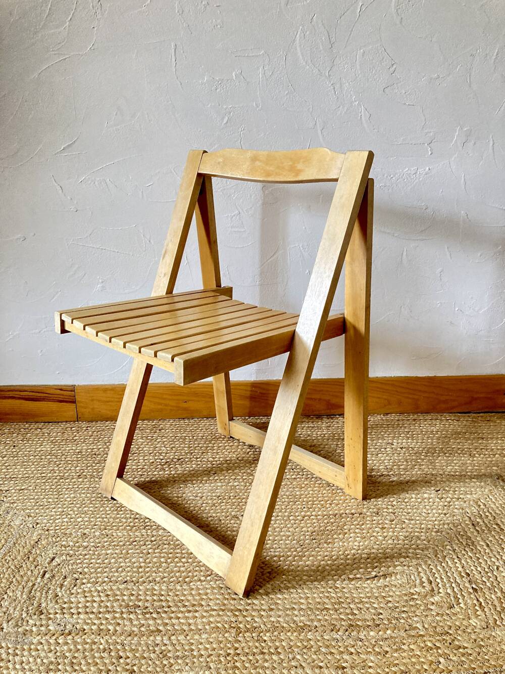 Folding chairs designed by Aldo Jacober in solid beech wood.