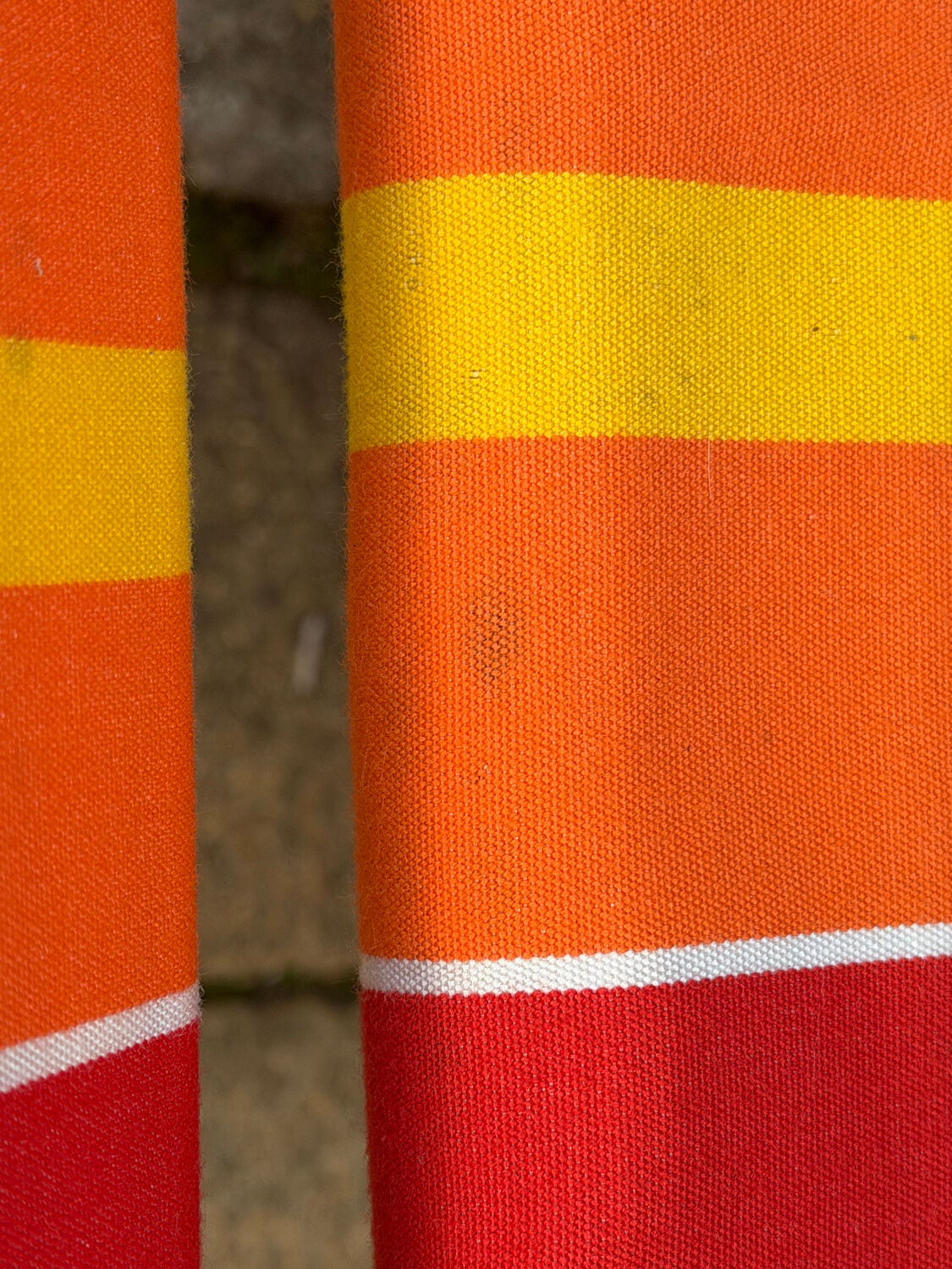 Vintage deck chair with red and orange striped fabric, original patina.