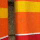 Vintage deck chair with red and orange striped fabric, original patina.