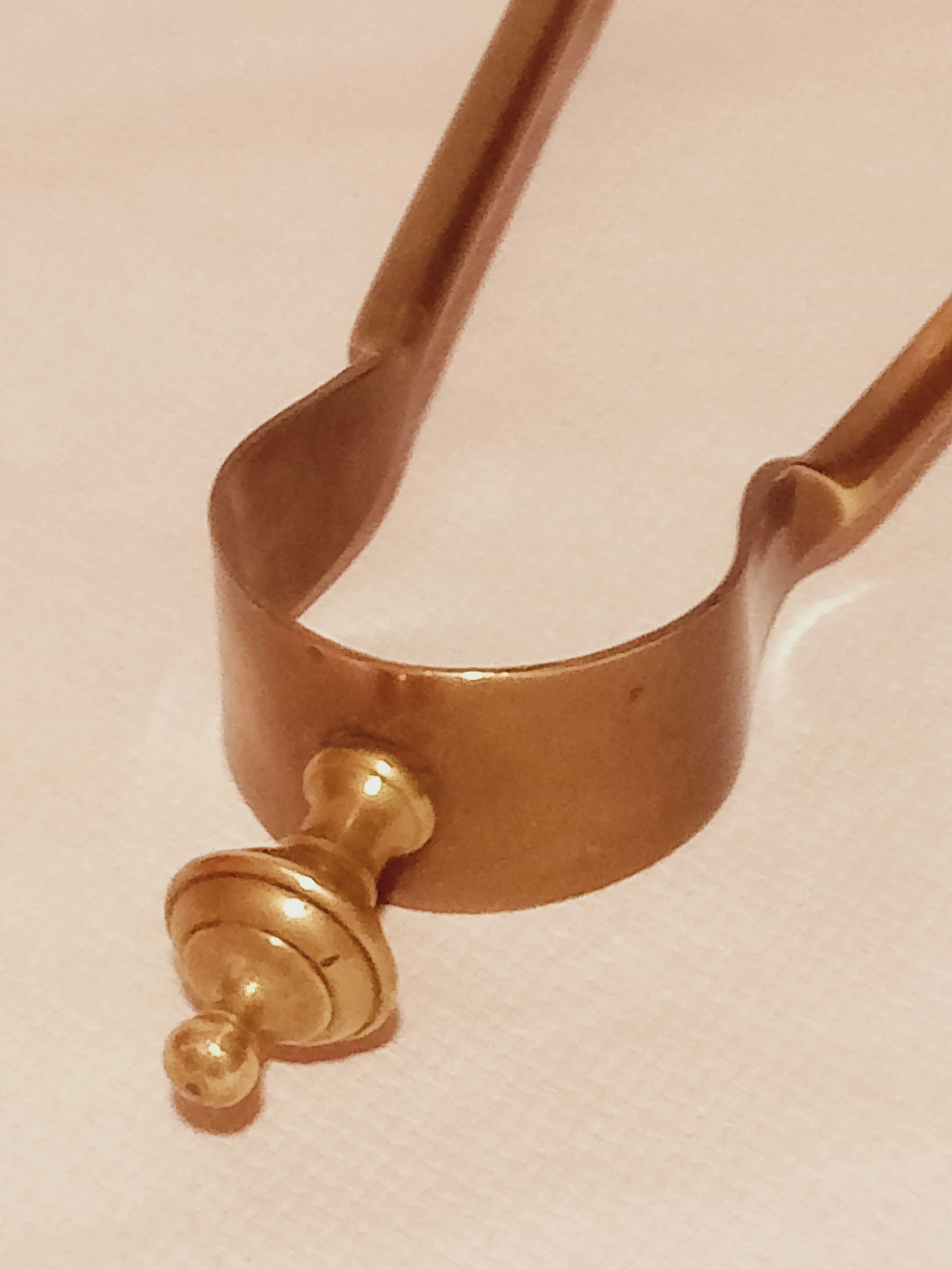 Old bronze or brass fireplace clamp