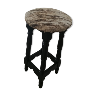 Black bar stool and skin of cattle.