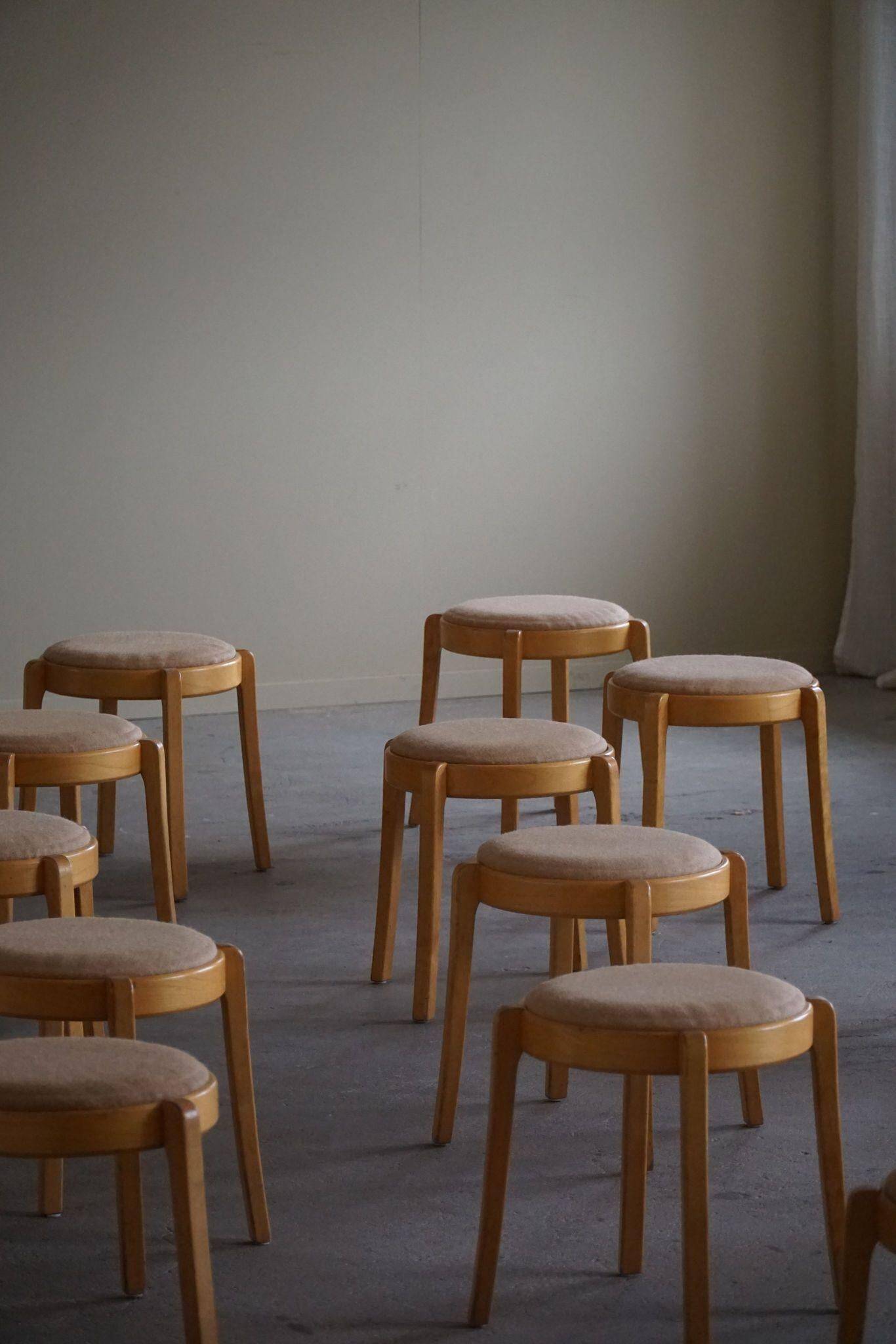 Modern Swedish, set of 14 stackable stools in birch and hessian fabric, 1980s.