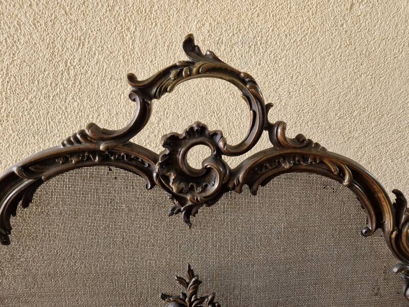 Spark screen, fire screen, bronze fireplace screen decorated with a covered cherub