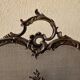 Spark screen, fire screen, bronze fireplace screen decorated with a covered cherub