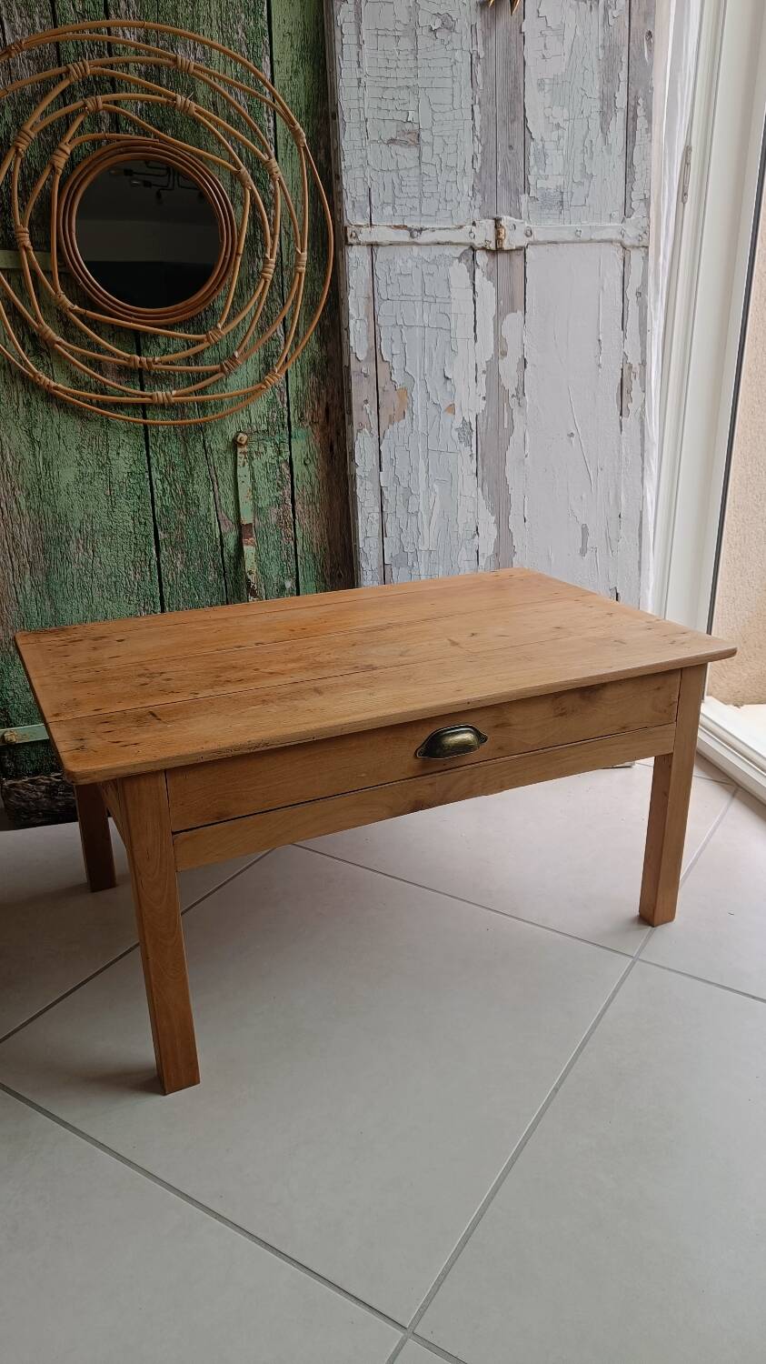 Coffee table with raw wood and a large drawer.