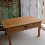 Coffee table with raw wood and a large drawer.