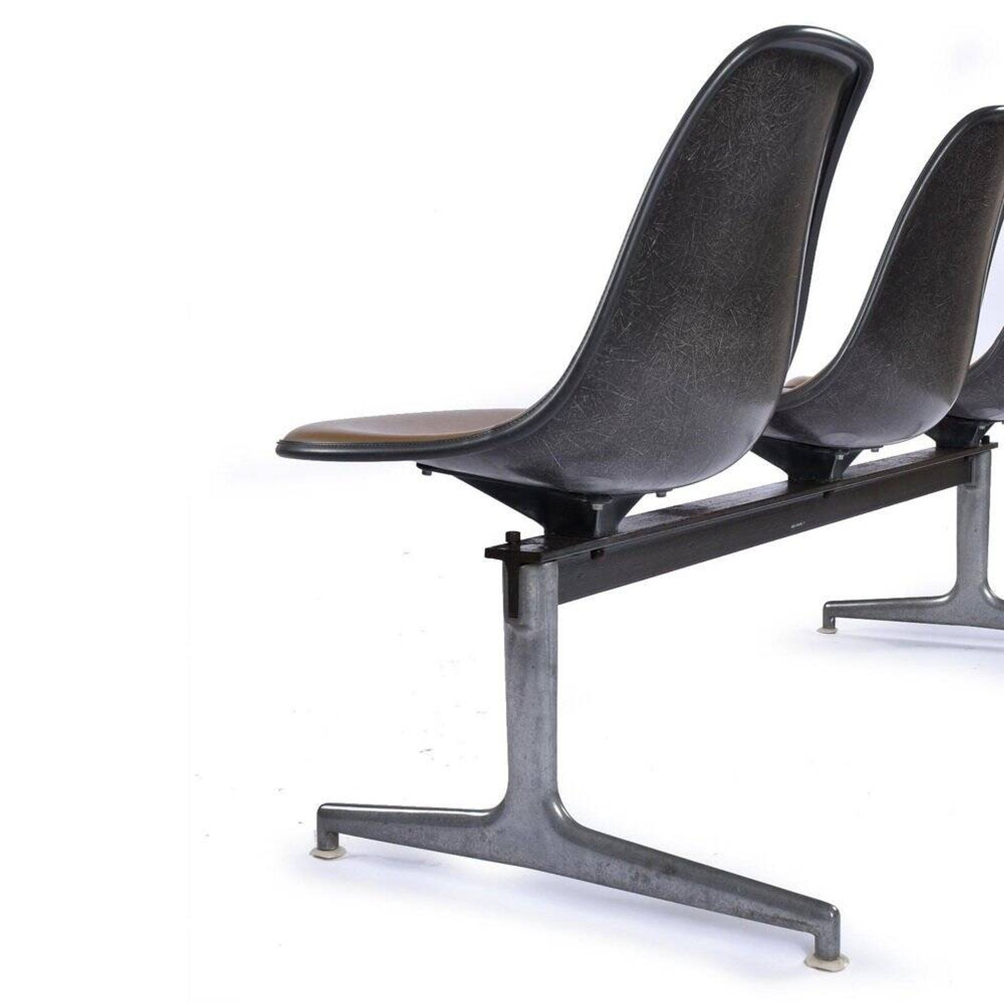 Tandem bench with brown Naugahyde pad shell chairs by Charles and Ray Eames for Herman Miller