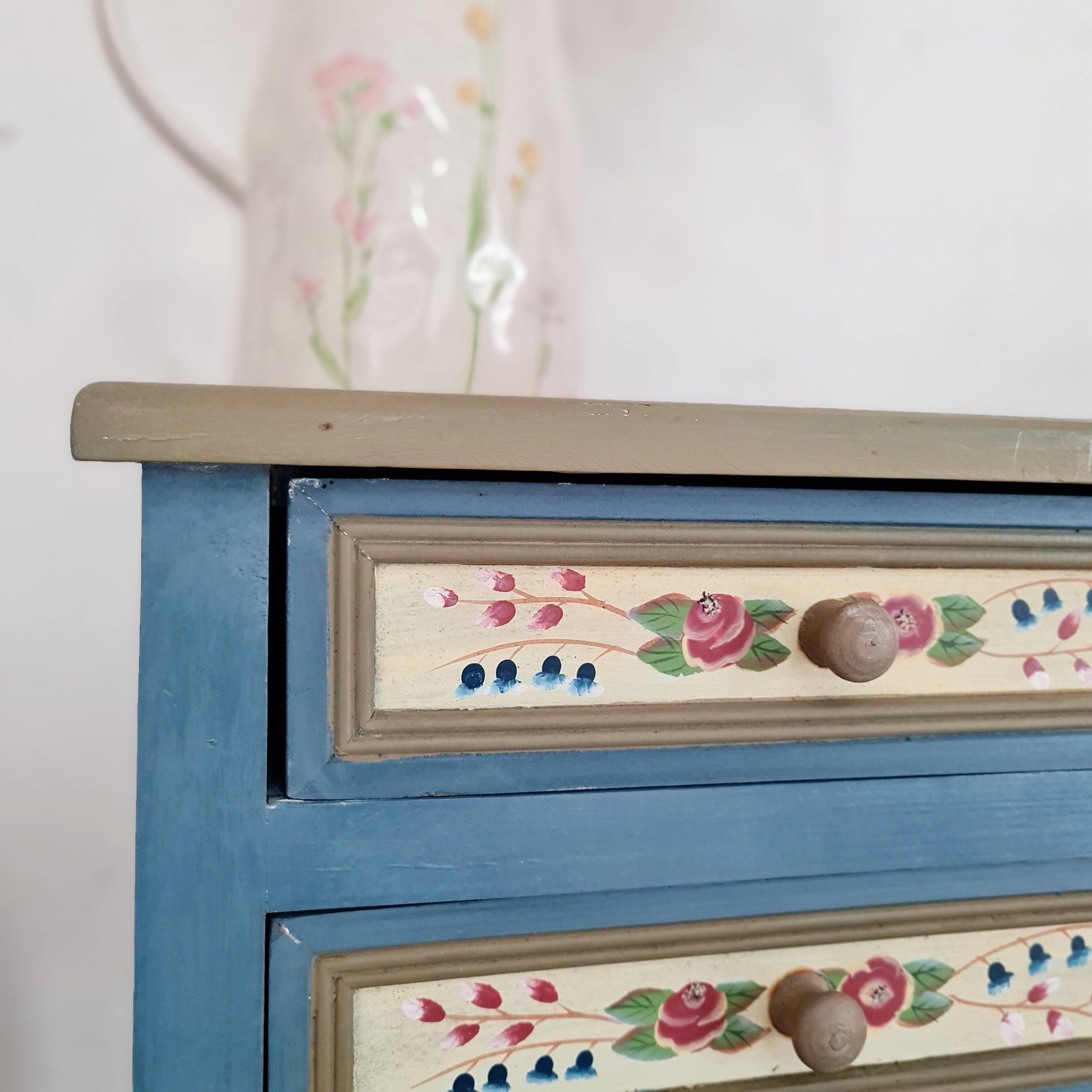 Blue wooden bedside tables with floral patterns